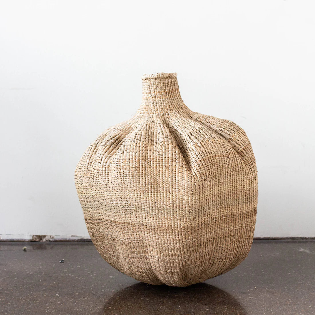 Handwoven Garlic Gourd Basket! Made by skilled Ndebele women weavers in Zimbabwe, each basket is one-of-a-kind and supports their livelihood. These decorative baskets are perfect for adding natural materials to your interior.