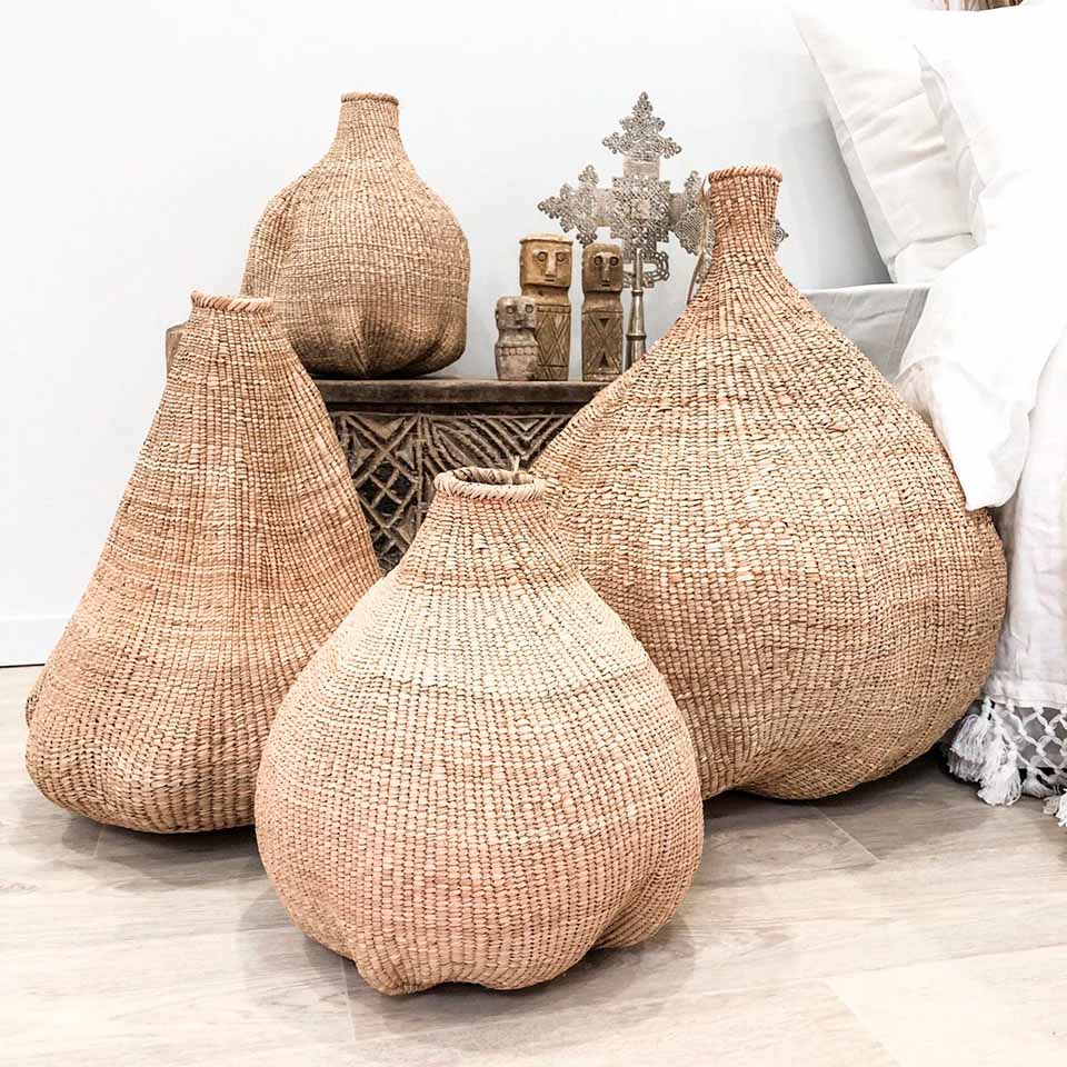 Handwoven Garlic Gourd Basket! Made by skilled Ndebele women weavers in Zimbabwe, each basket is one-of-a-kind and supports their livelihood. These decorative baskets are perfect for adding natural materials to your interior.
