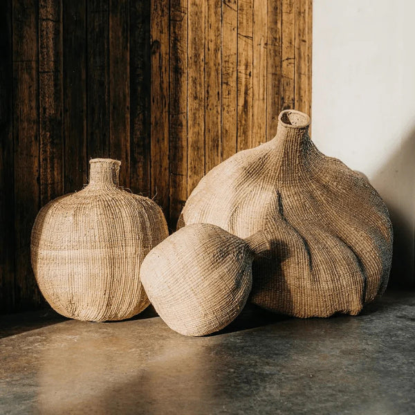 Handwoven Garlic Gourd Basket! Made by skilled Ndebele women weavers in Zimbabwe, each basket is one-of-a-kind and supports their livelihood. These decorative baskets are perfect for adding natural materials to your interior.