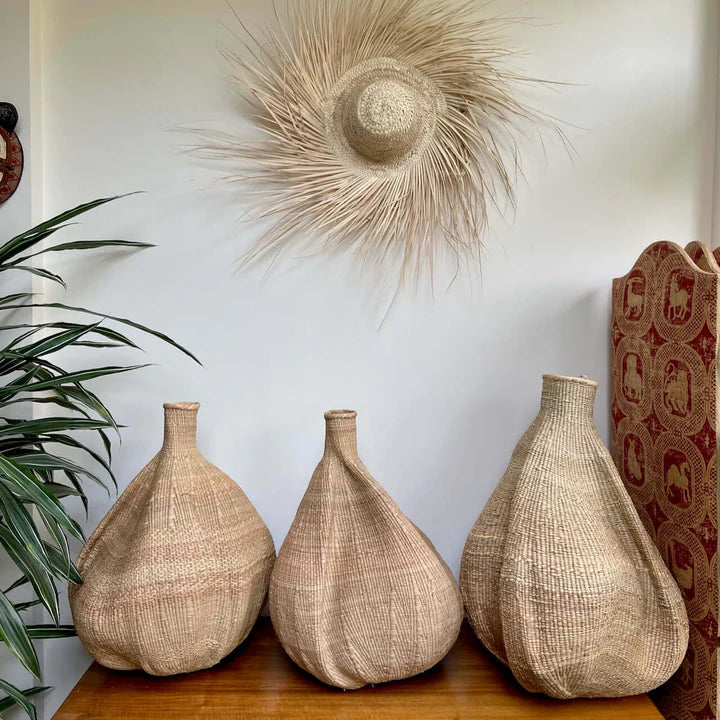 Handwoven Garlic Gourd Basket! Made by skilled Ndebele women weavers in Zimbabwe, each basket is one-of-a-kind and supports their livelihood. These decorative baskets are perfect for adding natural materials to your interior.