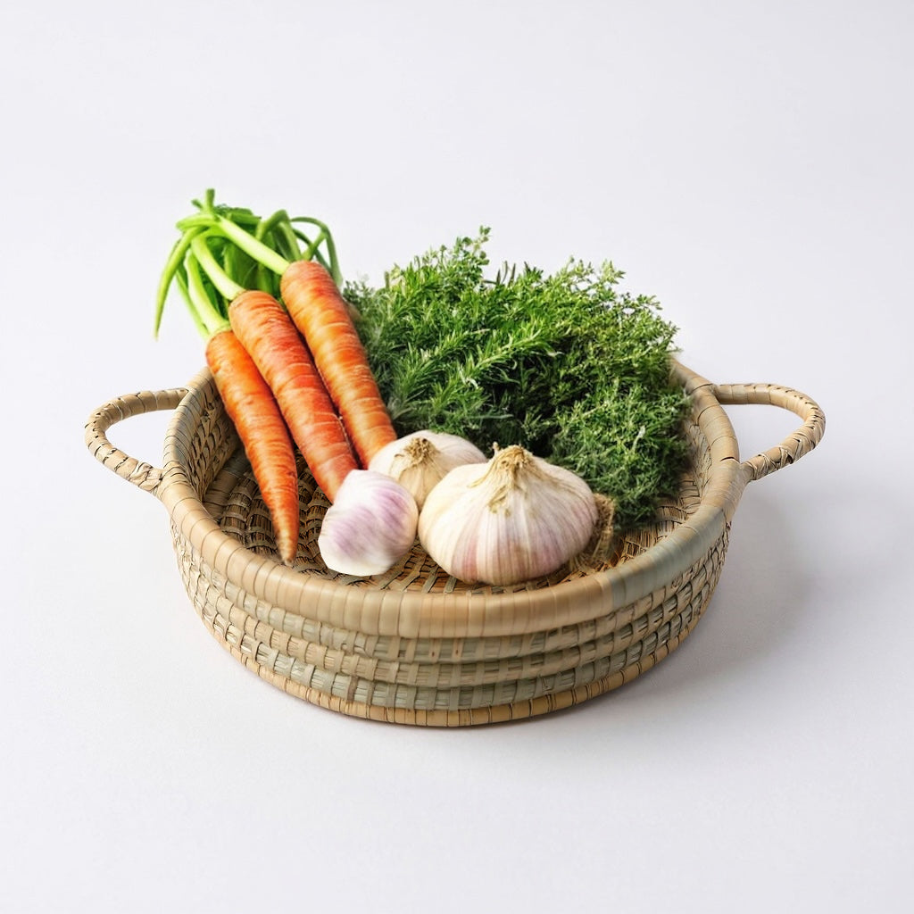Wicker basket with carrots, garlic, and herbs on a white background