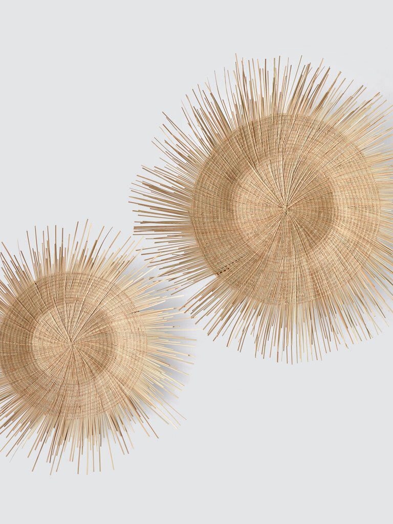 handcrafted Sun Circle wall art. Each piece is carefully woven by Malawian craftsman, incorporating unique spikes and tendrils of ilala palm. Bring natural texture and a touch of bohemian style to your home or office!