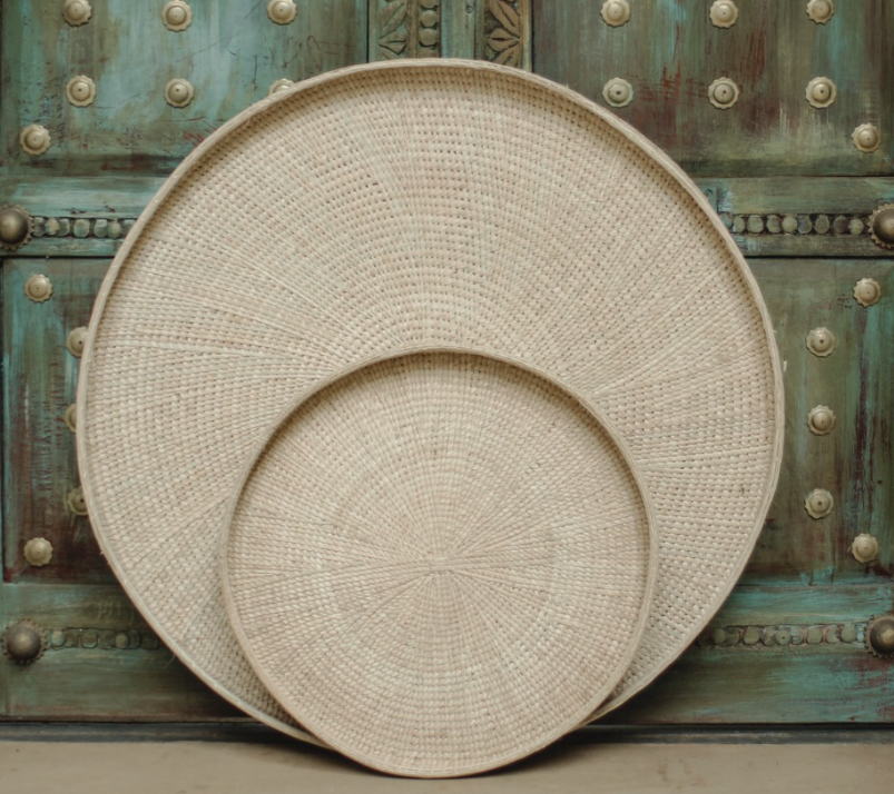 handwoven Round Trays, highly sought-after for their charm and craftsmanship, add an element of elegance and grace to any space. Crafted from ilala palm in Zimbabwe, these shallow trays serve as versatile storage solutions, perfect for kitchens, dining tables, bathrooms, or as striking wall accents, seamlessly blending functionality with aesthetic appeal. These catch-all trays are great for display or for storing everyday items such as keys, remotes or magazines.