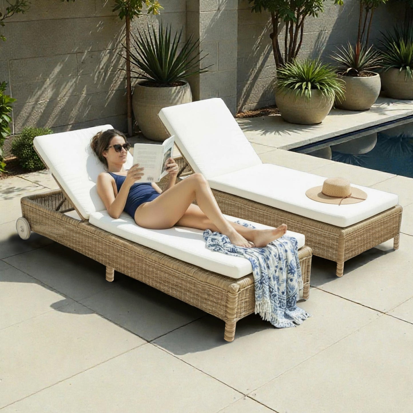 Woman relaxing on a wicker sun lounger by a poolside