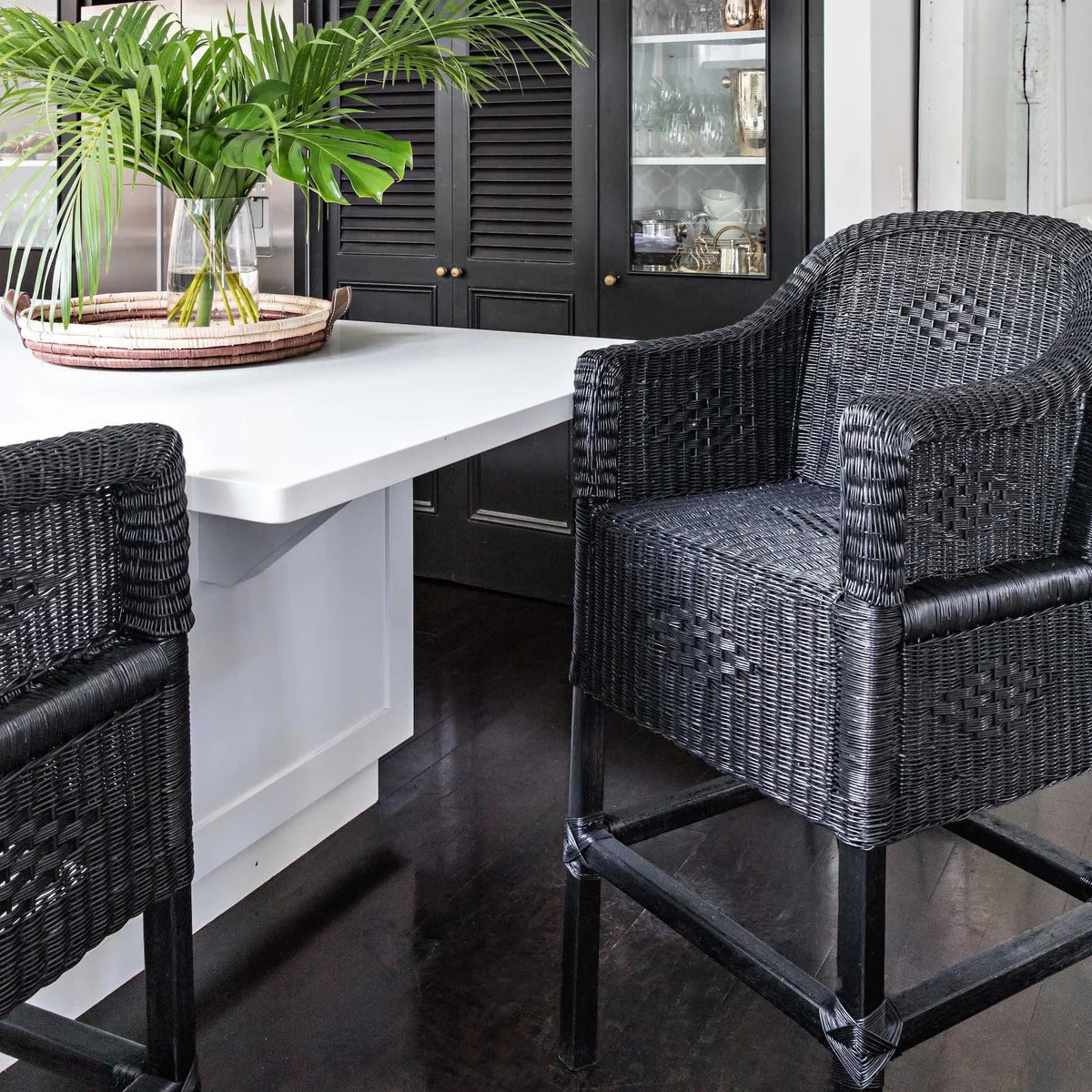 Classic Malawian cane bar stool Chair painted black in A Modern and chick homely Space.