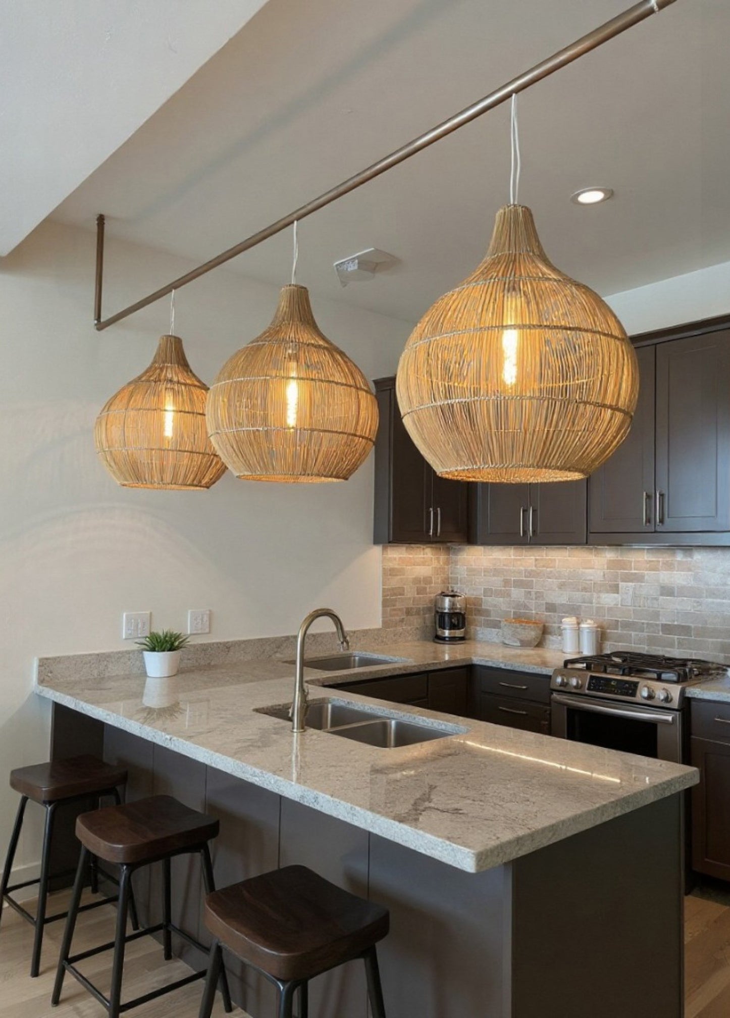 3 Bell shaped Malawi Cane Woven lampshades in a kitchen