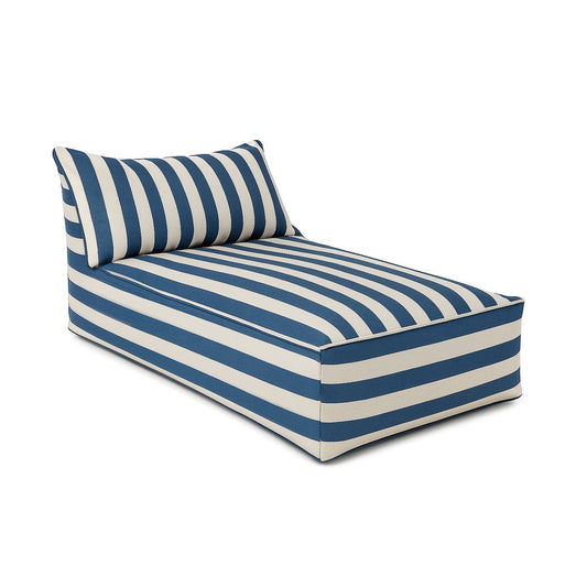 A rectangular daybed lounger with a bold blue and white striped fabric, featuring a low, boxy base and a matching angled backrest cushion. The clean white background highlights the modern, casual design and crisp piping detail along the seams.