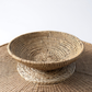 the Buhera Dish elevates any space with its natural charm and functionality. Whether used as a decorative accent or for storage, it adds an organic touch to your home. Perfect for everyday items and throws, displaying on a wall, or holding fruits and vegetables, the Buhera Dish is a stunning addition to your home.