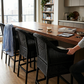 Malawi Furniture classic cane bar stool chairs painted black in a natural wicker weave, styled as organic modern kitchen counter seating with sturdy wooden legs.