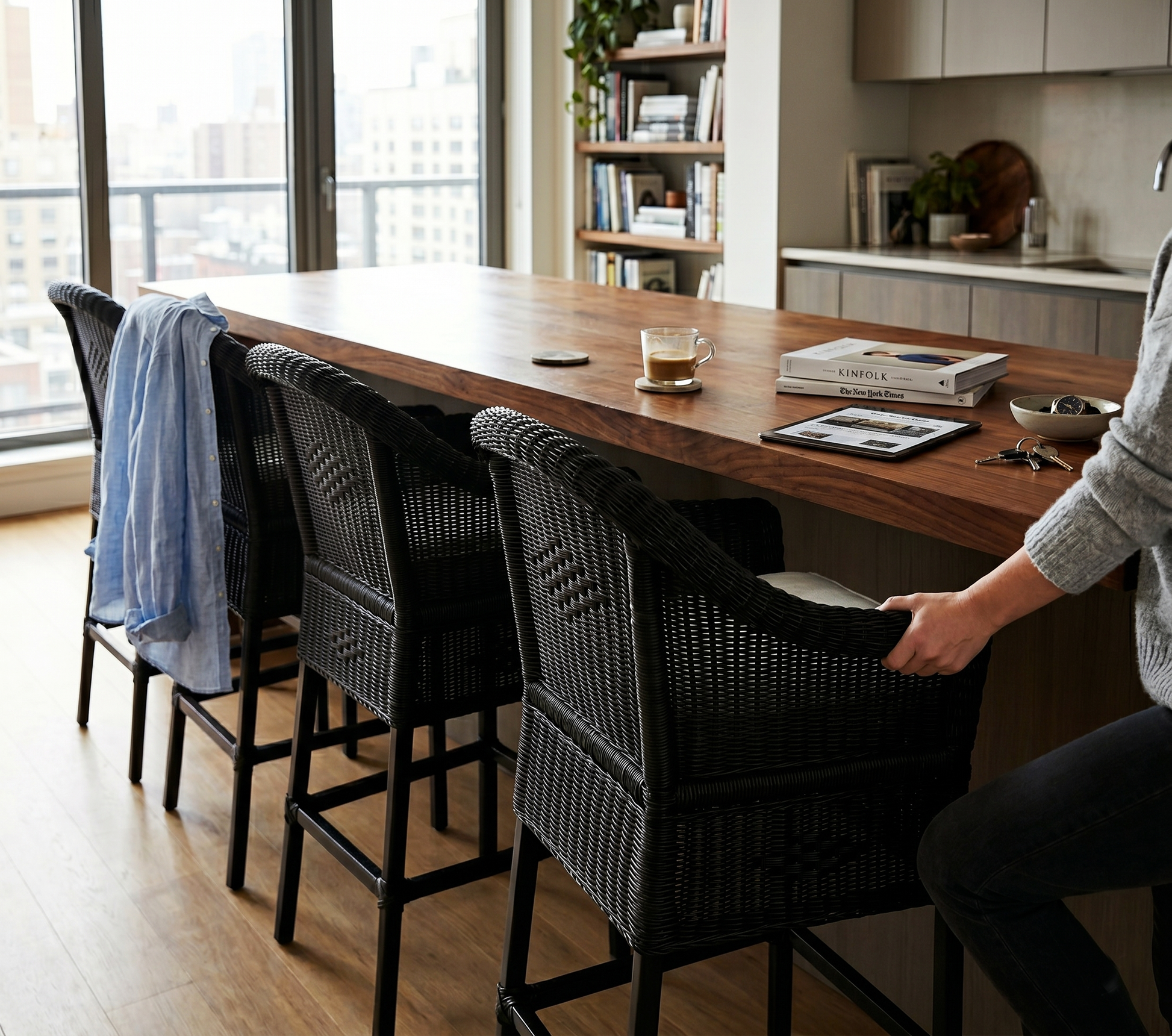 Malawi Furniture classic cane bar stool chairs painted black in a natural wicker weave, styled as organic modern kitchen counter seating with sturdy wooden legs.