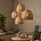 Malawi Furniture trio of woven cane dome pendant shades hung together as a modern statement light fixture for a high ceiling, dining room, or entrance hall.