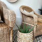 Franschhoek Guest Lodge - Handwoven cane Malawi Classic Chairs with Porcupine Planter Pot. This artisan-crafted set creates a natural, sophisticated focal point on the patio. Shop these unique, authentic pieces from Malawi Furniture.