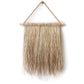 Hanging Grass Wall Decor. Handcrafted hanging grass wall art by Malawi Furniture, featuring natural dried organic ilala palm and seagrass onto a sustainable wooden dowel. Large 90cm by 1m boho fringed wall hanging in a light natural brown tone for minimalist home decor.