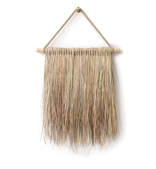 Hanging Grass Wall Decor. Handcrafted hanging grass wall art by Malawi Furniture, featuring natural dried organic ilala palm and seagrass onto a sustainable wooden dowel. Large 90cm by 1m boho fringed wall hanging in a light natural brown tone for minimalist home decor.