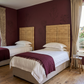 Malawi Furniture - Authentic and textural solid headboard made from Malawi cane. Headboard adds rich, organic texture to any bedroom. Paired with crimson floral wall paper.