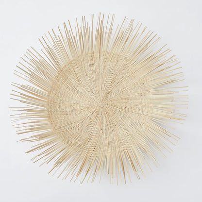 Handcrafted Sun Circle wall art. Each piece is carefully woven by Malawian craftsman, incorporating unique spikes and tendrils of ilala palm. Bring natural texture and a touch of bohemian style to your home or office!