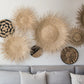 Handcrafted Sun Circle wall art. Each piece is carefully woven by Malawian craftsman, incorporating unique spikes and tendrils of ilala palm. Bring natural texture and a touch of bohemian style to your home or office!