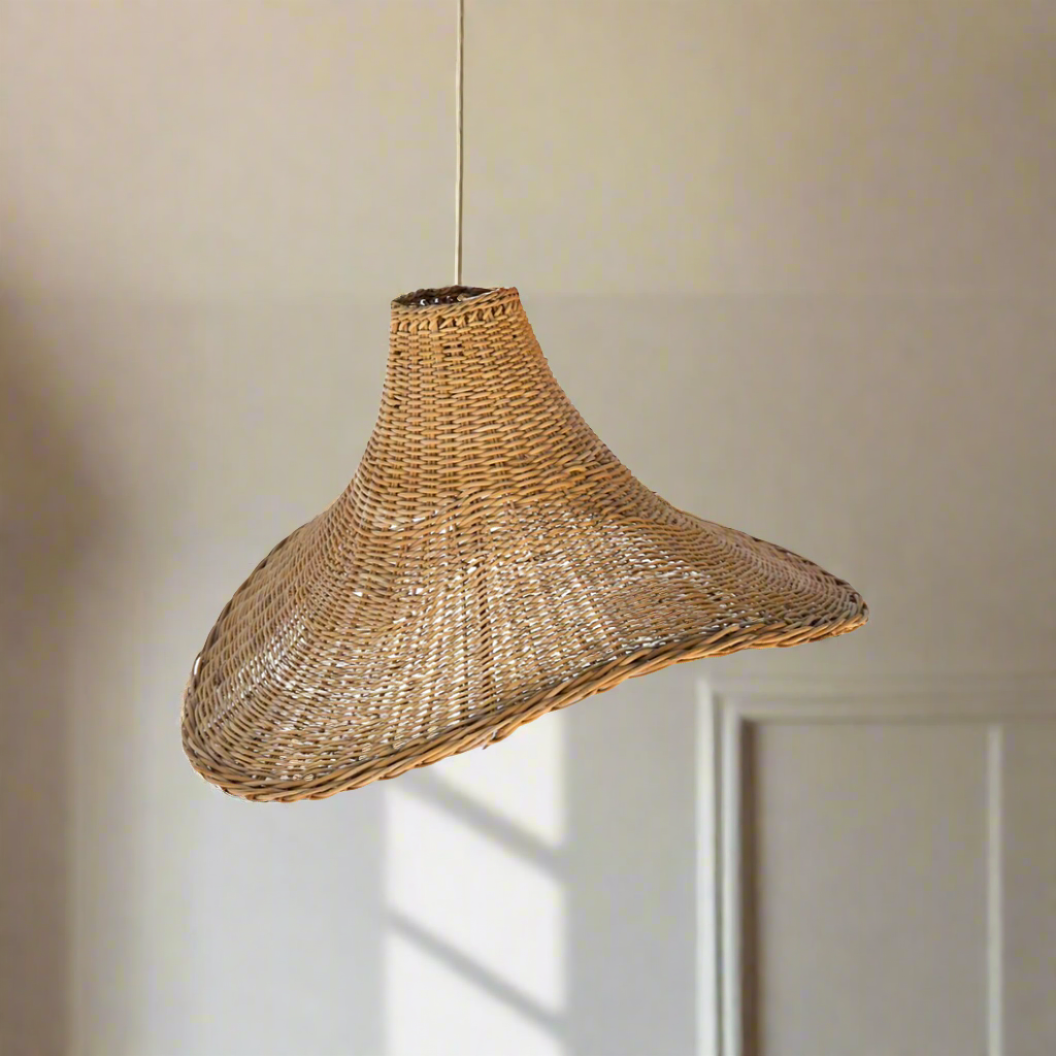 Transform your living space into a serene haven with our handcrafted Malawi Wave pendant lampshade. Made from Malawi cane by skilled artisans, its intricate weave patterns and organic shape create a captivating focal point. Experience the warm, dappled light and rich heritage of this unique piece, perfect for solo display or enchanting clusters.