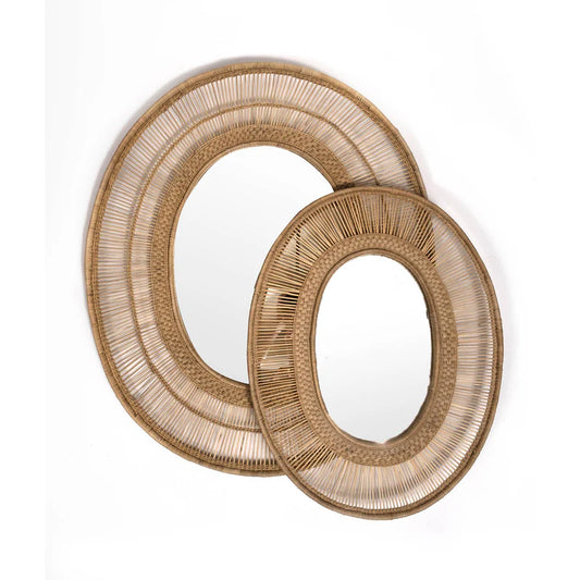 hand-woven cane and bamboo mirror. Crafted by skilled artisans, this exquisite oval piece is perfect for adding a touch of rural charm to any living space. Use it as a unique focal point or mix and match it with other decorative items. Please note: The frame is handmade in Malawi and strengthened in the UK for durability. The mirror is securely fastened using backing board and twine.